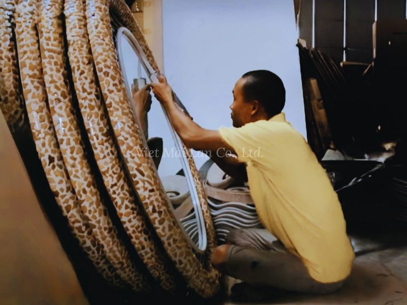 Artisan Crafting A Mother Of Pearl Mirror
